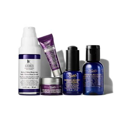 Five skincare products arranged in a group, featuring a serum, a cream, and two recovery concentrate bottles, all from Kiehl's with a focus on anti-aging and skin recovery.
