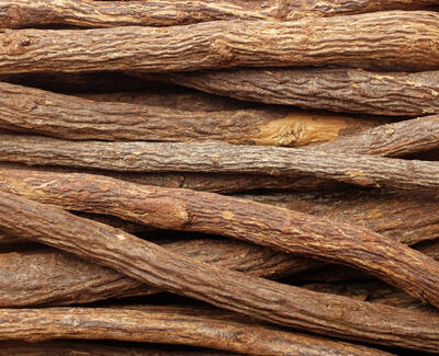 A close-up view of a pile of dried wood sticks, showcasing their textured surfaces and various shades of brown.
