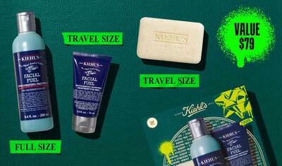 A graphic, set against a dark green textured background, features three Kiehl’s products. A blue bottle of "KIEHL’S FACIAL FUEL INVIGORATING FACE WASH" is labeled "FULL SIZE" in bright green. A dark blue tube of "KIEHL’S FACIAL FUEL MOISTURIZER" is labeled "TRAVEL SIZE" in bright green. A bar of "KIEHL’S 'ULTIMATE MAN' BODY SCRUB SOAP" is also labeled "TRAVEL SIZE" in bright green. In the lower right, a partially visible green Kiehl’s gift box showcases the same three products.